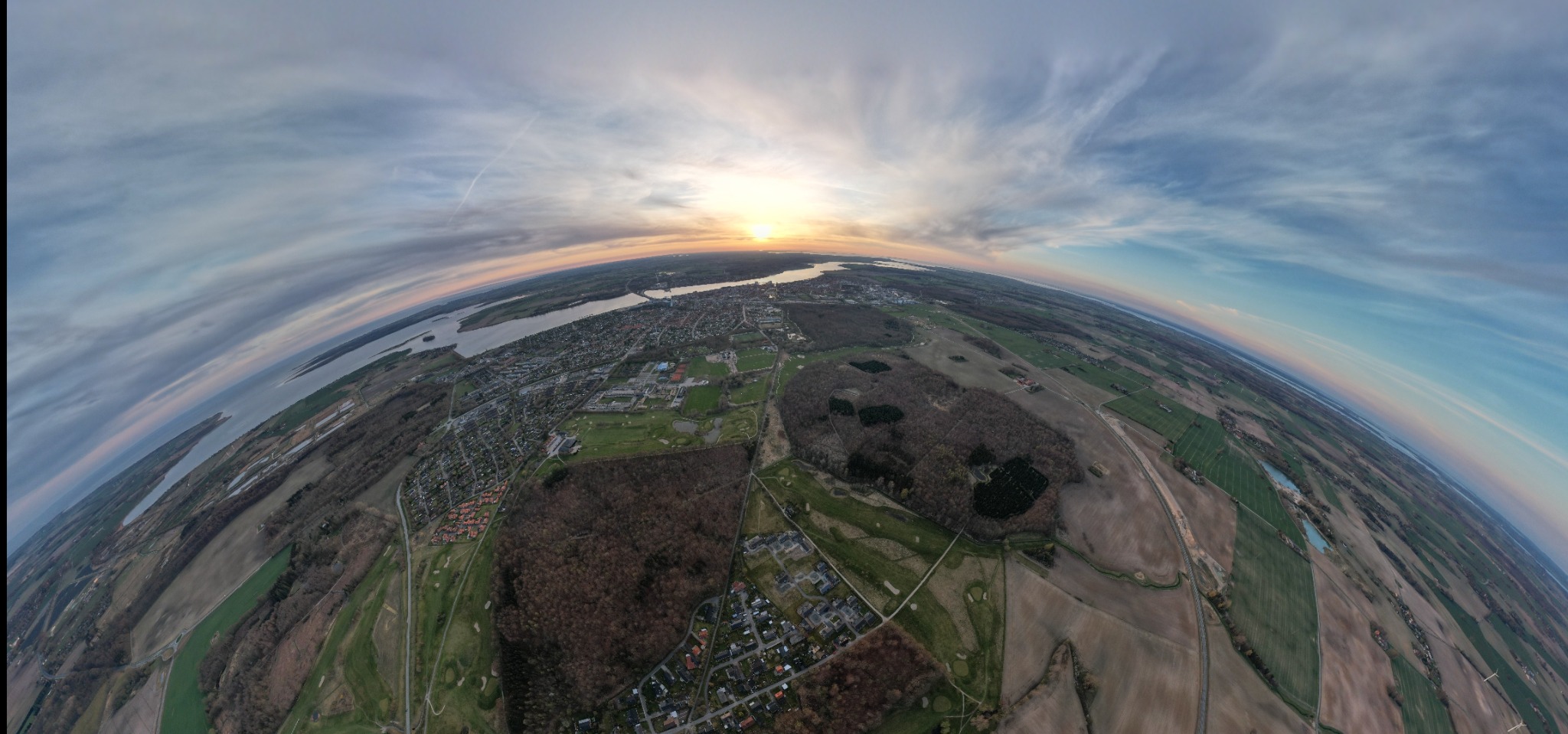 Vidvinkelpanorama over by og landskab fra luften